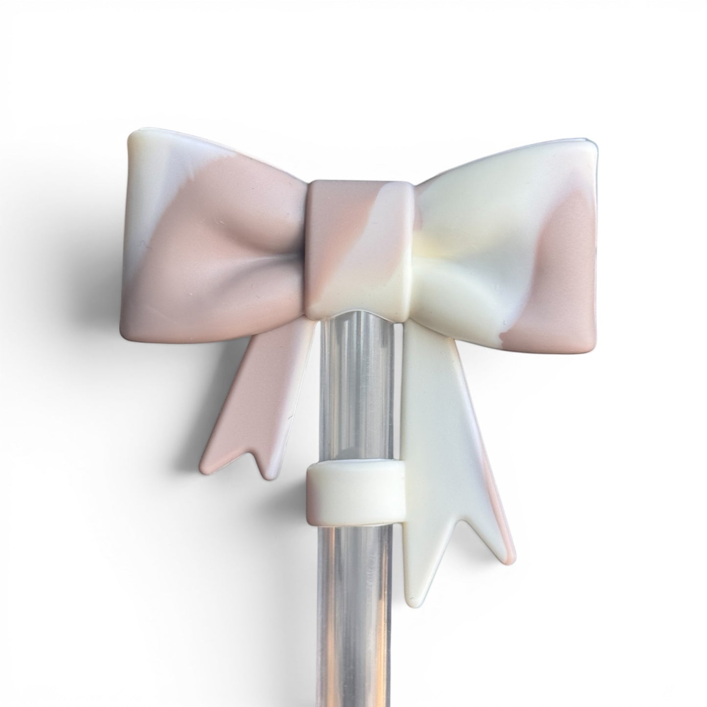 Next Nirvana almond rose bay silicone 3D bow straw topper with a matte marbled finish on a clear straw
