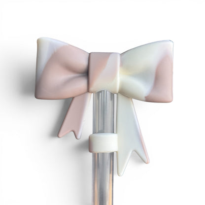 Next Nirvana almond rose bay silicone 3D bow straw topper with a matte marbled finish on a clear straw