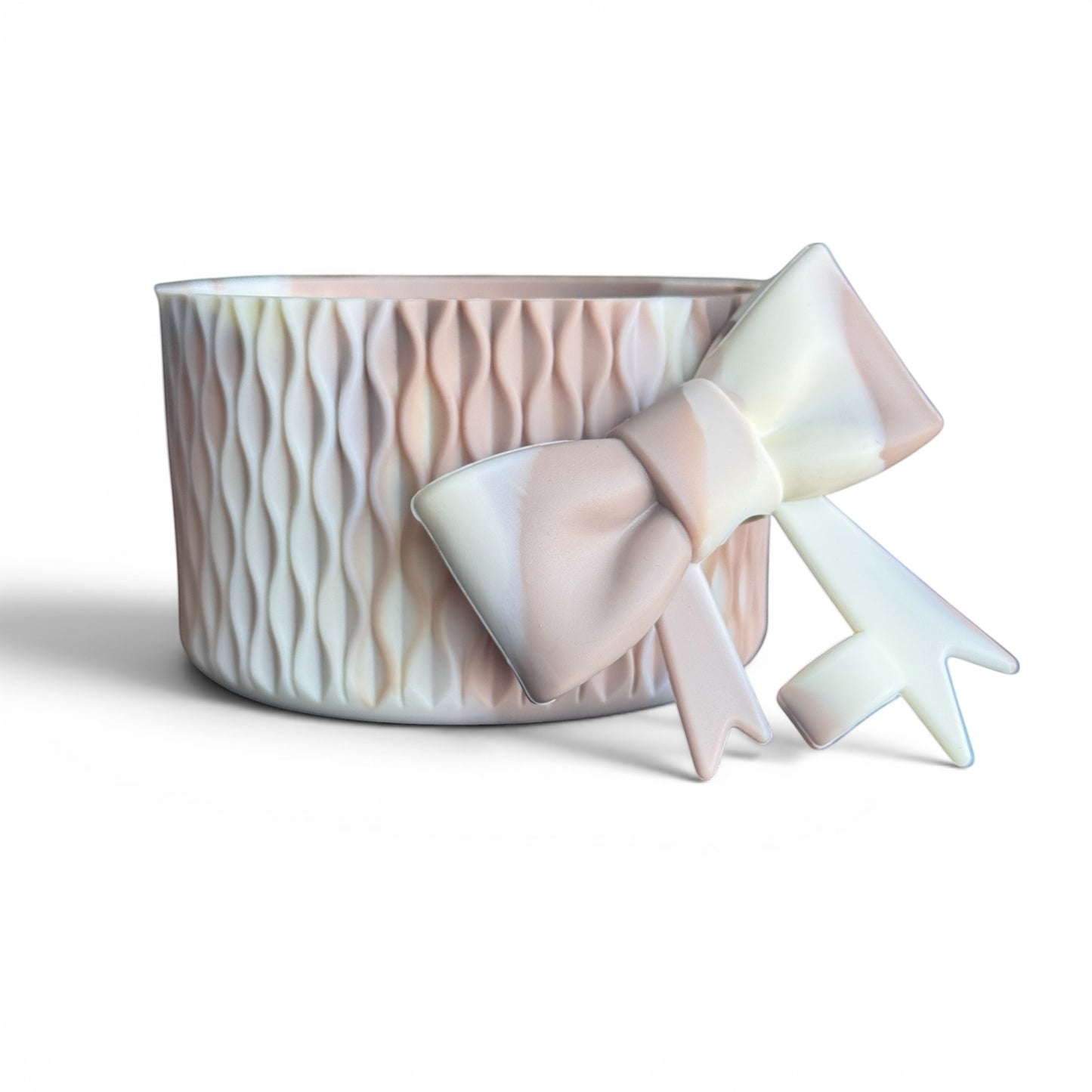 Next Nirvana almond rose bay silicone tumbler boot and matching 3D bow straw topper with a matte wave texture.