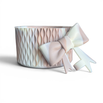 Next Nirvana almond rose bay silicone tumbler boot and matching 3D bow straw topper with a matte wave texture.
