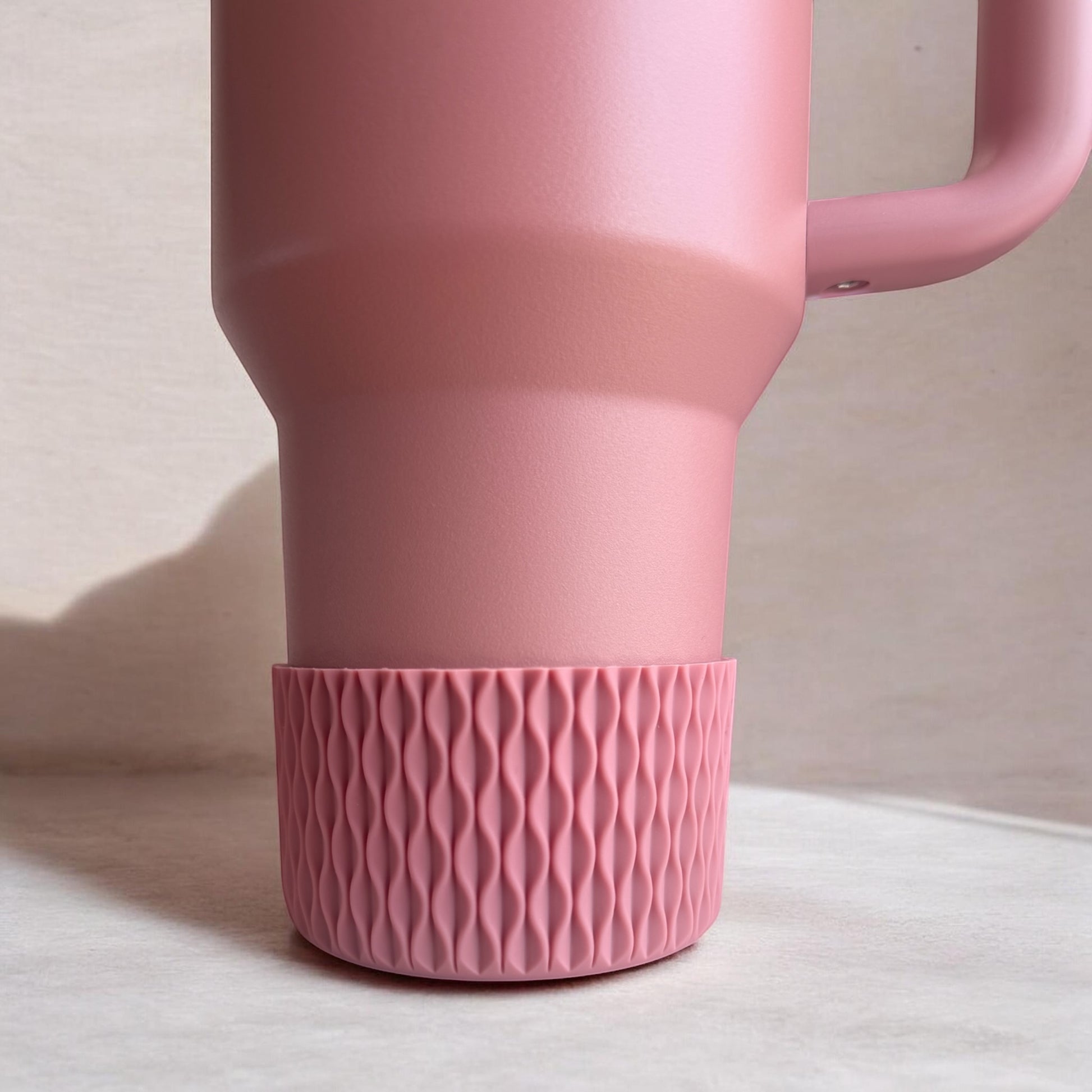 Next Nirvana antique pink silicone tumbler boot with a 3D matte wave texture on a matching pink insulated cup.