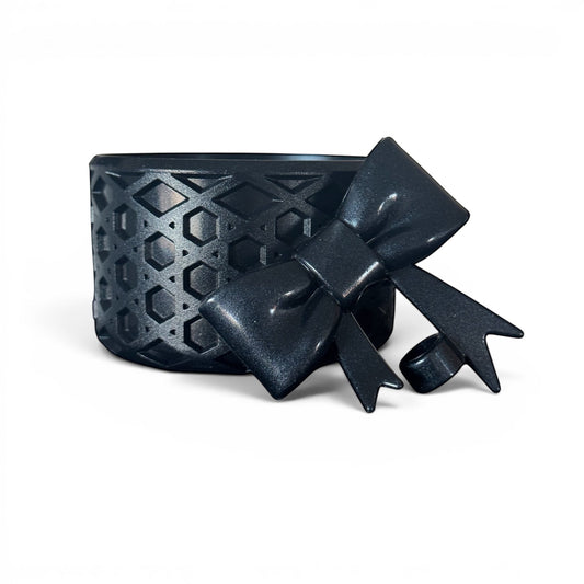 Next Nirvana Black Ice shimmer waffle-textured silicone tumbler boot and 3D bow straw topper set for insulated cups.