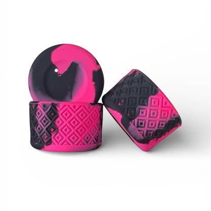 Next Nirvana silicone tumbler boot in black and neon pink swirl with a textured diamond pattern for cup protection.