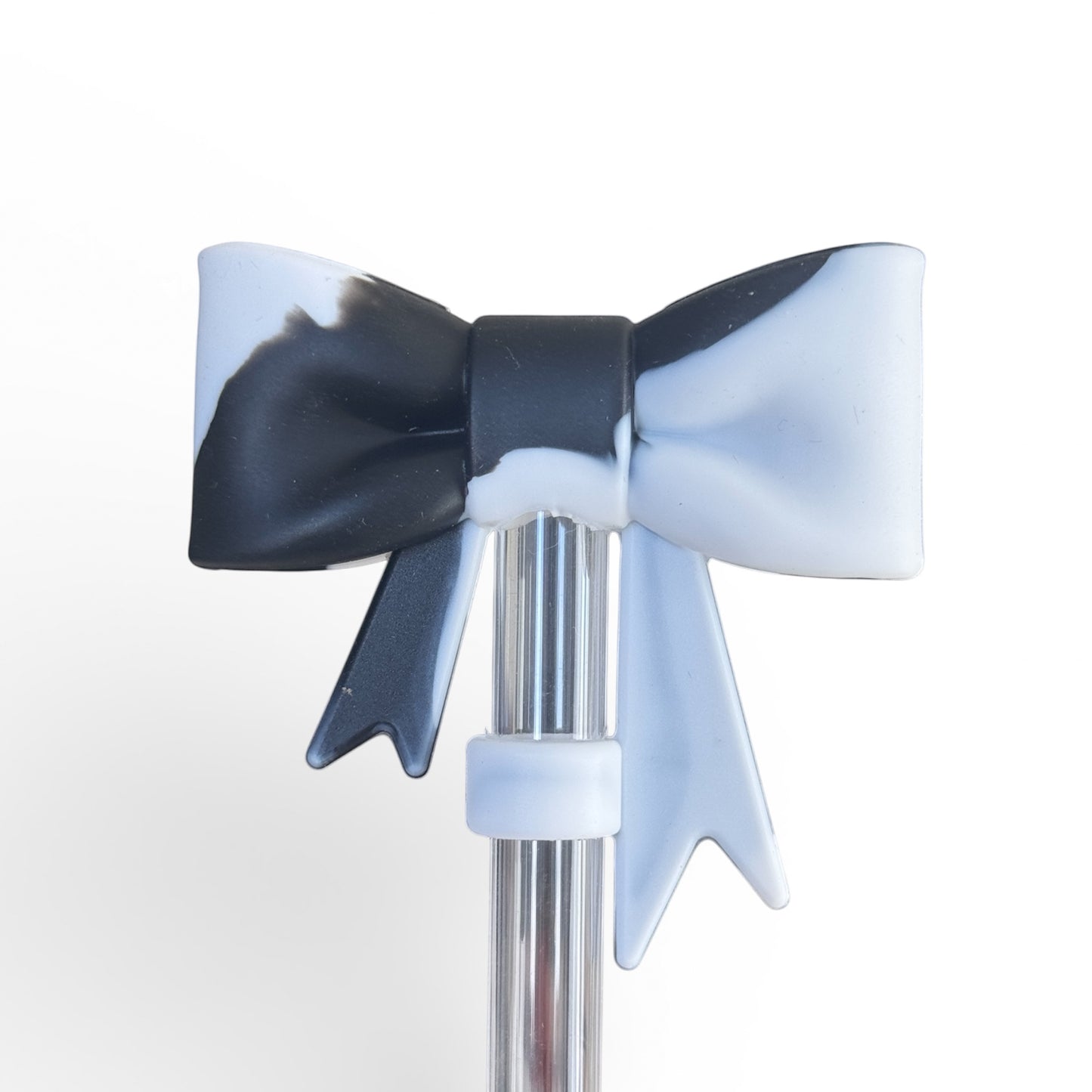 Next Nirvana black and white marble silicone bow tumbler accessory on a clear straw