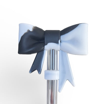 Next Nirvana black and white marble silicone bow tumbler accessory on a clear straw
