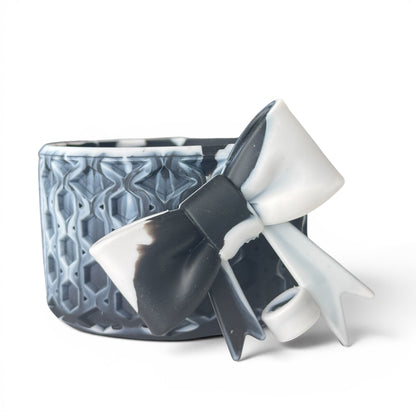 Next Nirvana black and white marble silicone tumbler boot with a 3D waffle texture and decorative bow accessory.