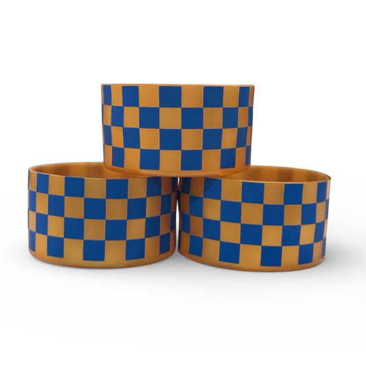 Next Nirvana silicone tumbler boot featuring a blue and gold checkered pattern for Stanley and other tumblers.
