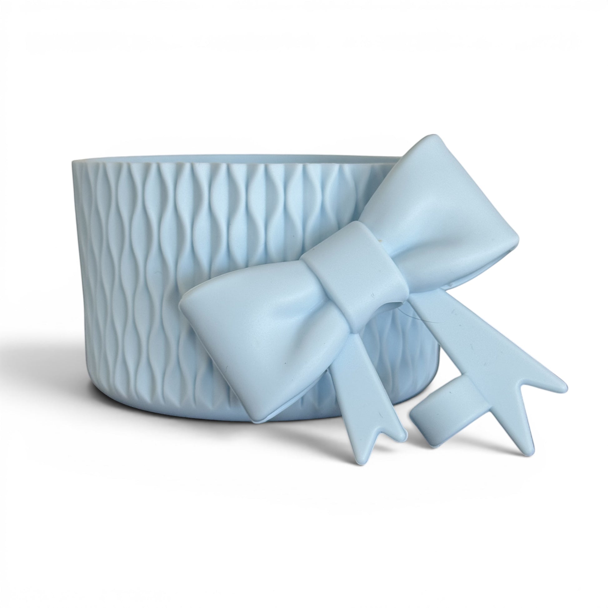 Next Nirvana light blue matte silicone tumbler boot with wavy texture and matching 3D bow straw topper accessory.