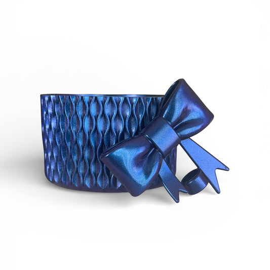 Next Nirvana blue silicone tumbler boot and matching 3D bow straw topper with a textured wave pattern.
