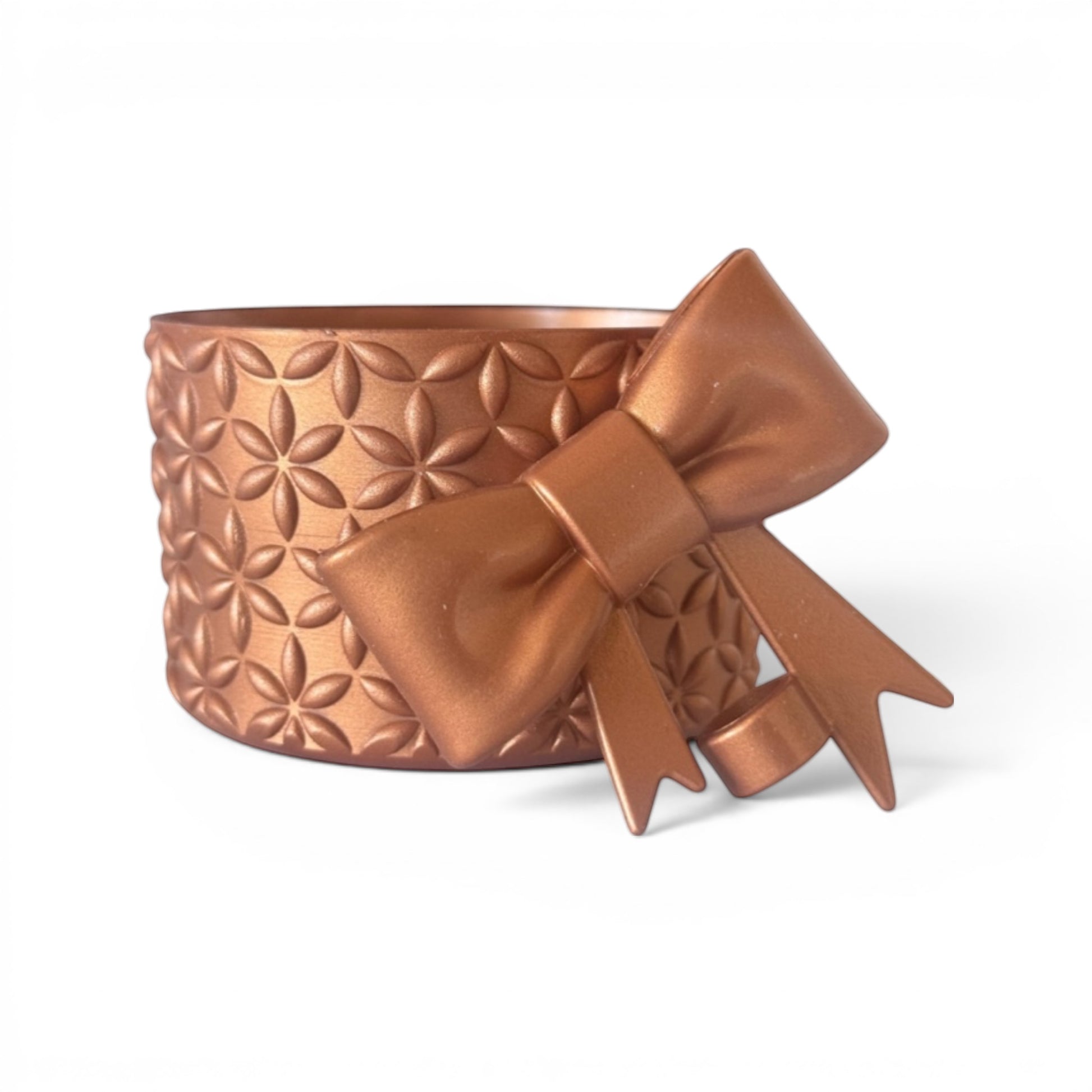 Next Nirvana bronze silicone tumbler boot with floral pattern and matching 3D bow straw topper for insulated cups.