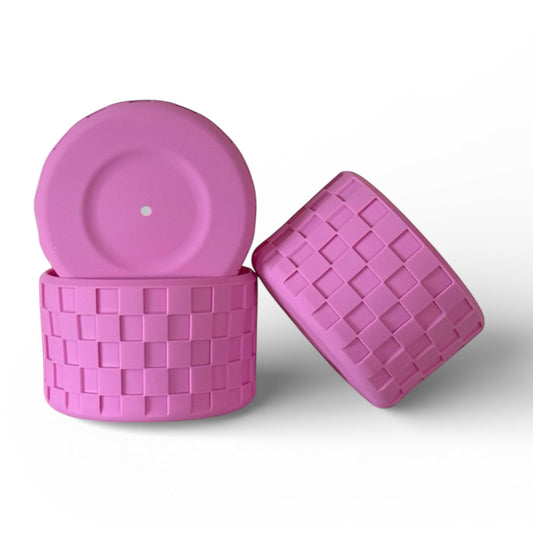 Next Nirvana bubblegum pink silicone tumbler boot with a textured checkerboard pattern for protective cup coverage.