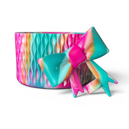 Next Nirvana Cabana Crush shimmer silicone tumbler boot and 3D bow straw topper in a vibrant multi-color wave pattern.