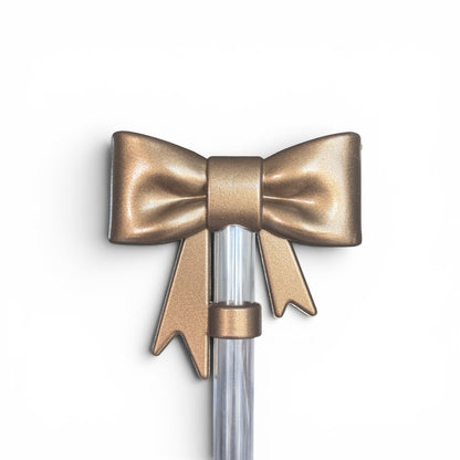 Next Nirvana champagne-colored 3D silicone bow straw topper for tumblers, featuring a textured, elegant design.