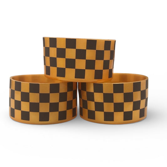 Next Nirvana silicone tumbler boot in chocolate and gold checkered pattern for protective non-slip base