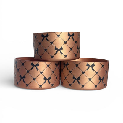 Next Nirvana copper silicone tumbler boot with black criss cross bow and heart pattern for Stanley and other tumblers
