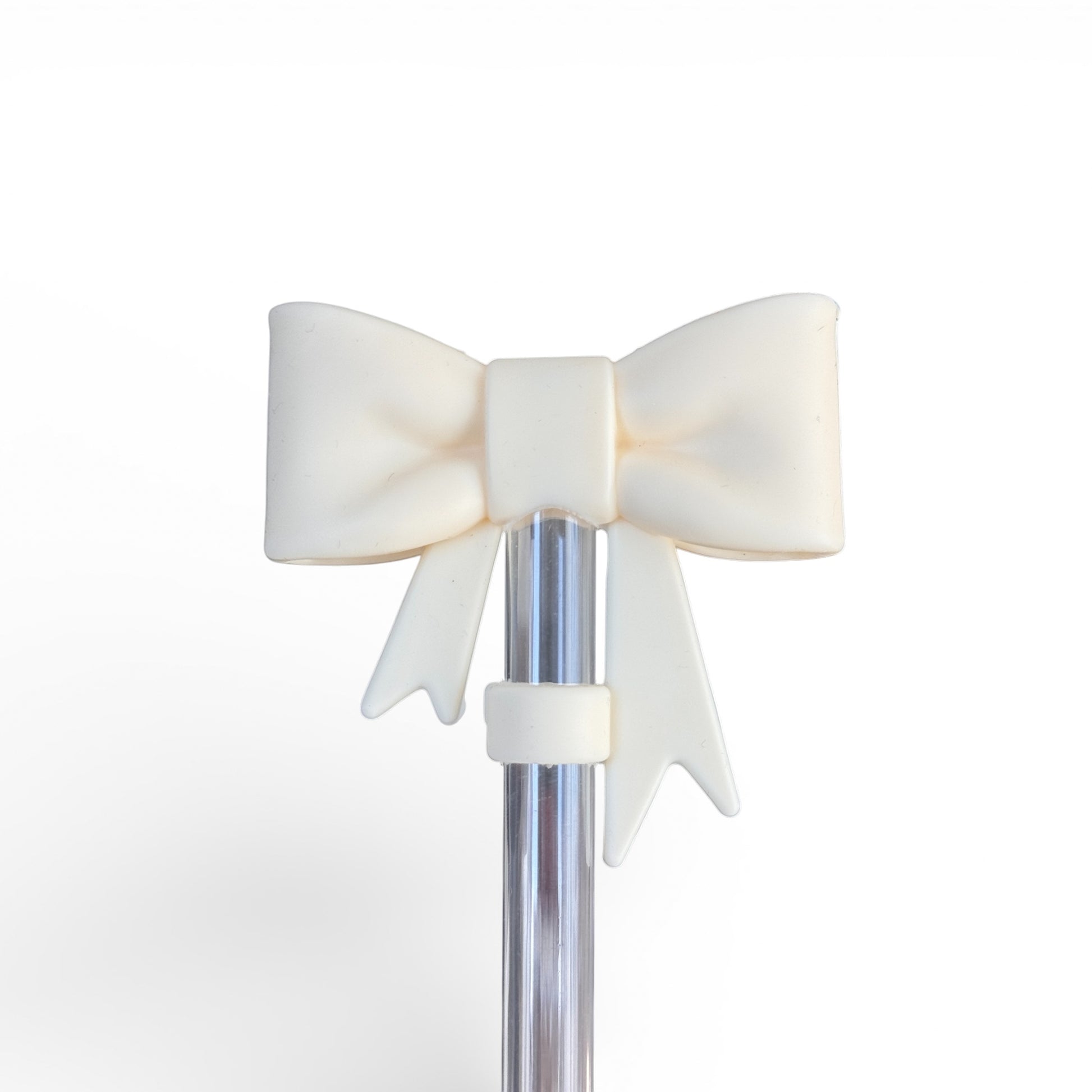 Next Nirvana cream silicone bow accessory attached to a clear straw for tumblers