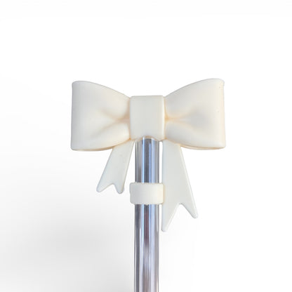 Next Nirvana cream silicone bow accessory attached to a clear straw for tumblers