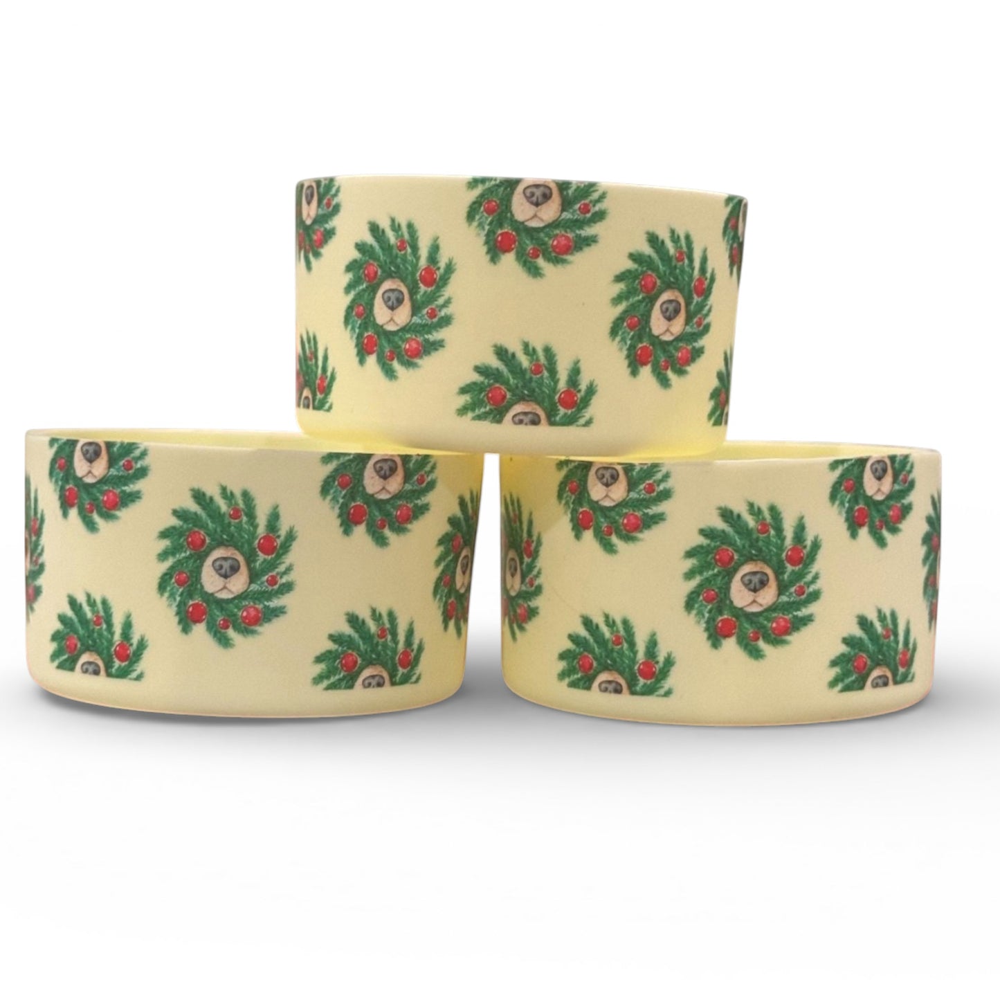 Next Nirvana Doggo Christmas silicone tumbler boot with festive wreath and dog face pattern on a cream background
