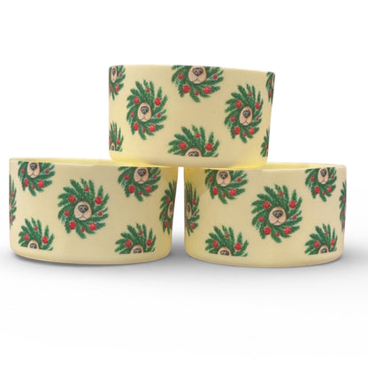 Next Nirvana Doggo Christmas silicone tumbler boot with festive wreath and dog face pattern on a cream background