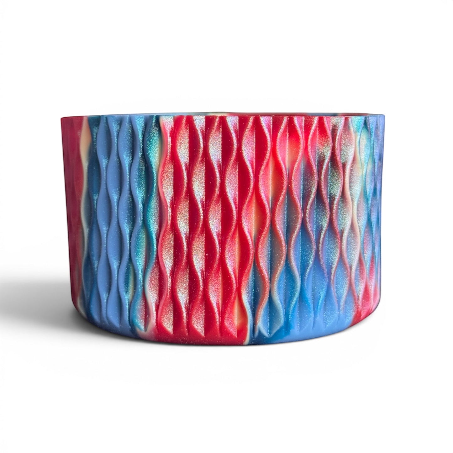 Next Nirvana Firecracker Bay shimmer silicone tumbler boot with a 3D wave texture in red and blue marbled colors.