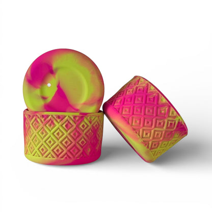 Next Nirvana fuchsia and lime silicone tumbler boot with a textured diamond pattern for protective cup base coverage