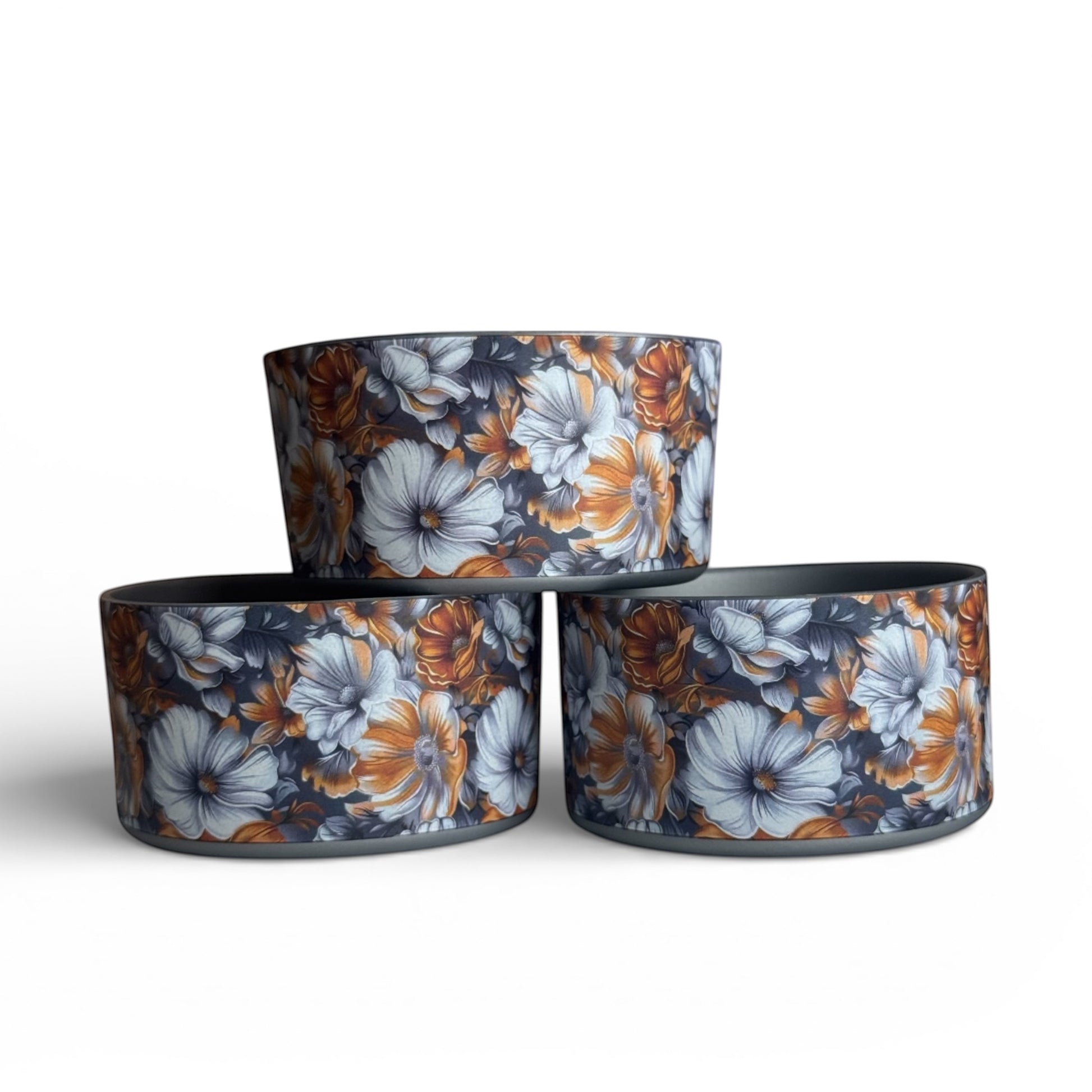 Next Nirvana Golden Bloom silicone tumbler boot with floral pattern in orange and grey for Stanley and other tumblers