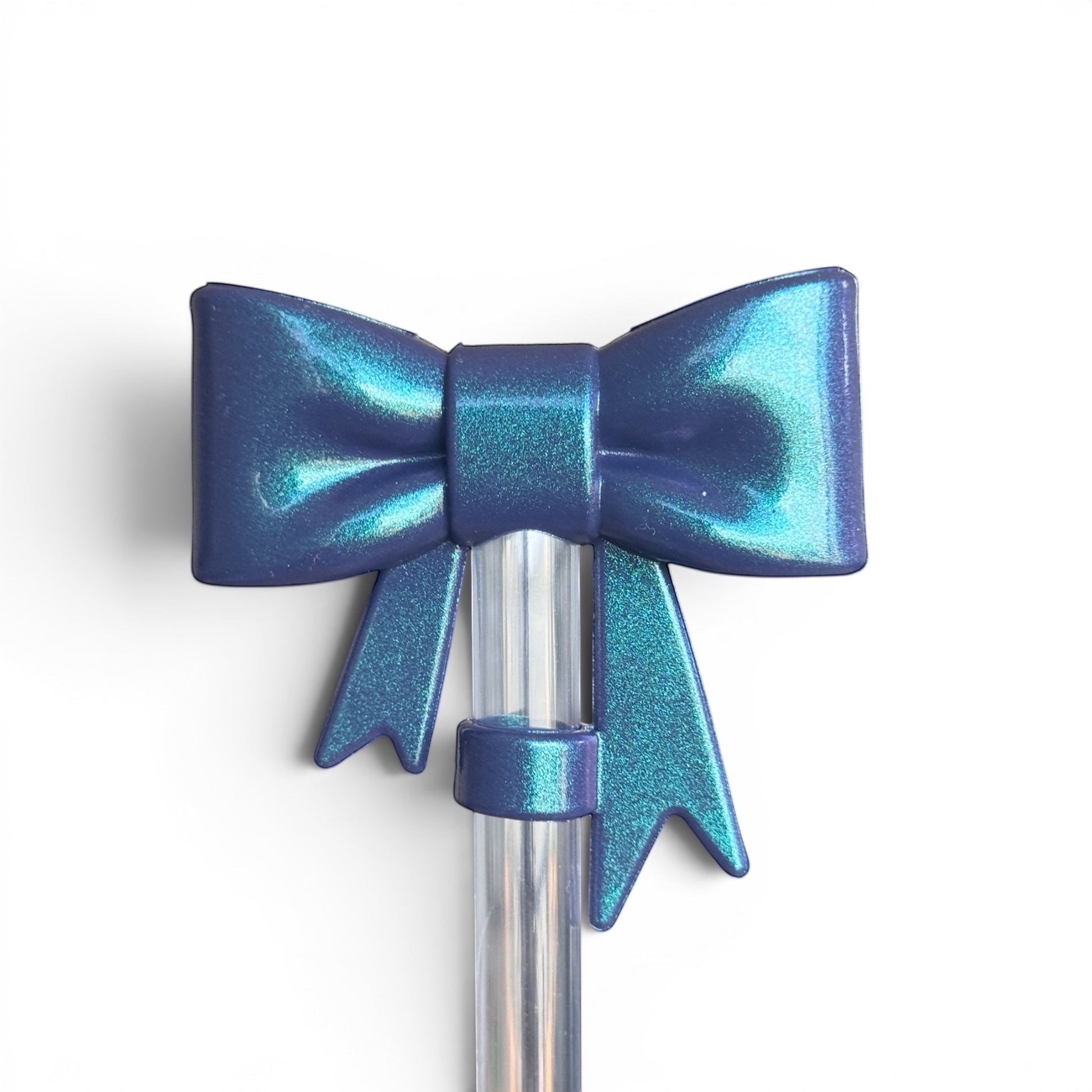 Next Nirvana navy shimmer 3D bow straw topper for tumblers, made of flexible BPA-free silicone with a metallic finish.