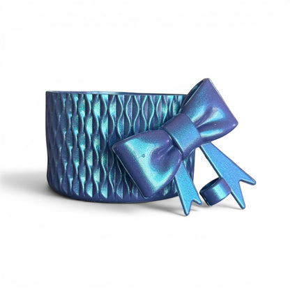 Next Nirvana navy shimmer silicone tumbler boot with matching 3D bow straw topper featuring a textured wave pattern.