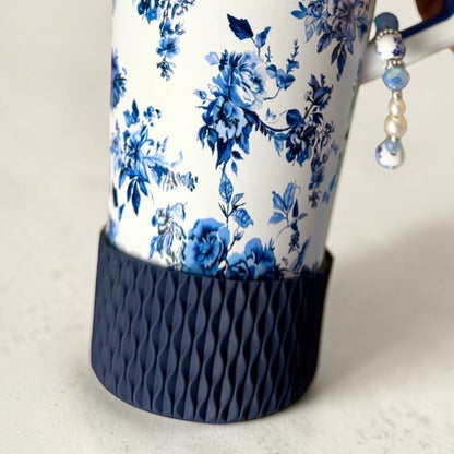 Next Nirvana navy silicone tumbler boot with a 3D wave texture on a floral patterned tumbler.