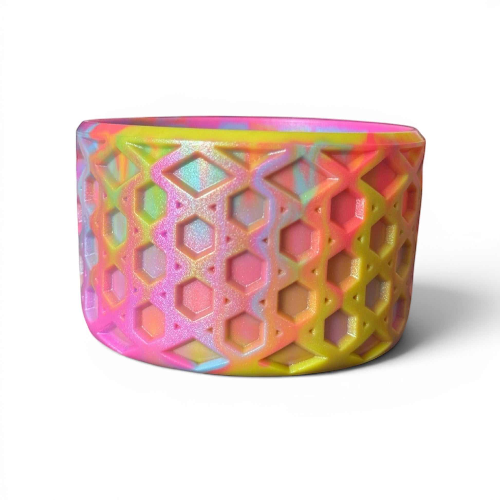 Next Nirvana neon shimmer waffle silicone tumbler boot with a 3D geometric pattern in pink, yellow, and blue.