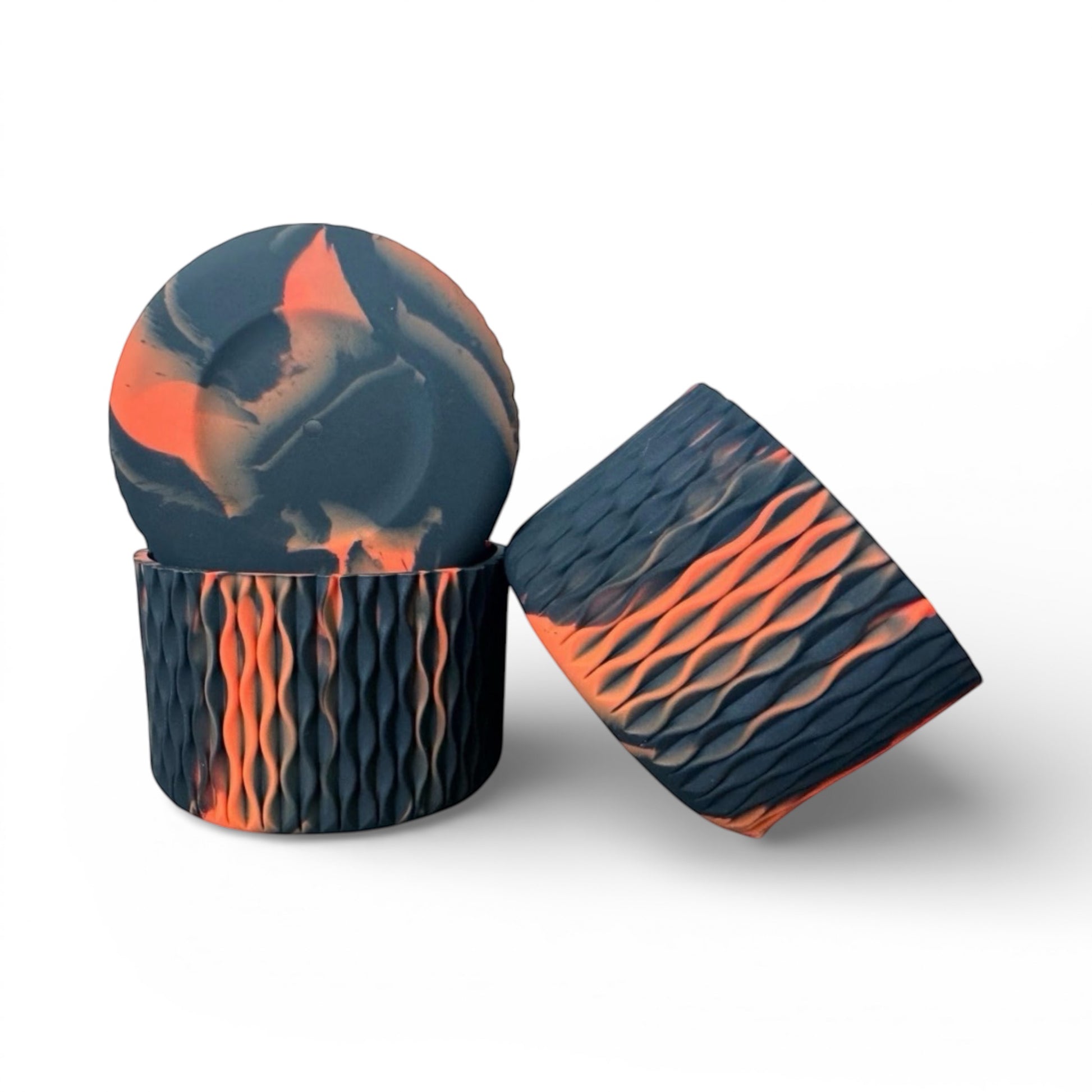 Next Nirvana orange and black silicone tumbler boot with a textured waves pattern for protective non-slip base