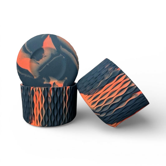 Next Nirvana orange and black silicone tumbler boot with a textured waves pattern for protective non-slip base