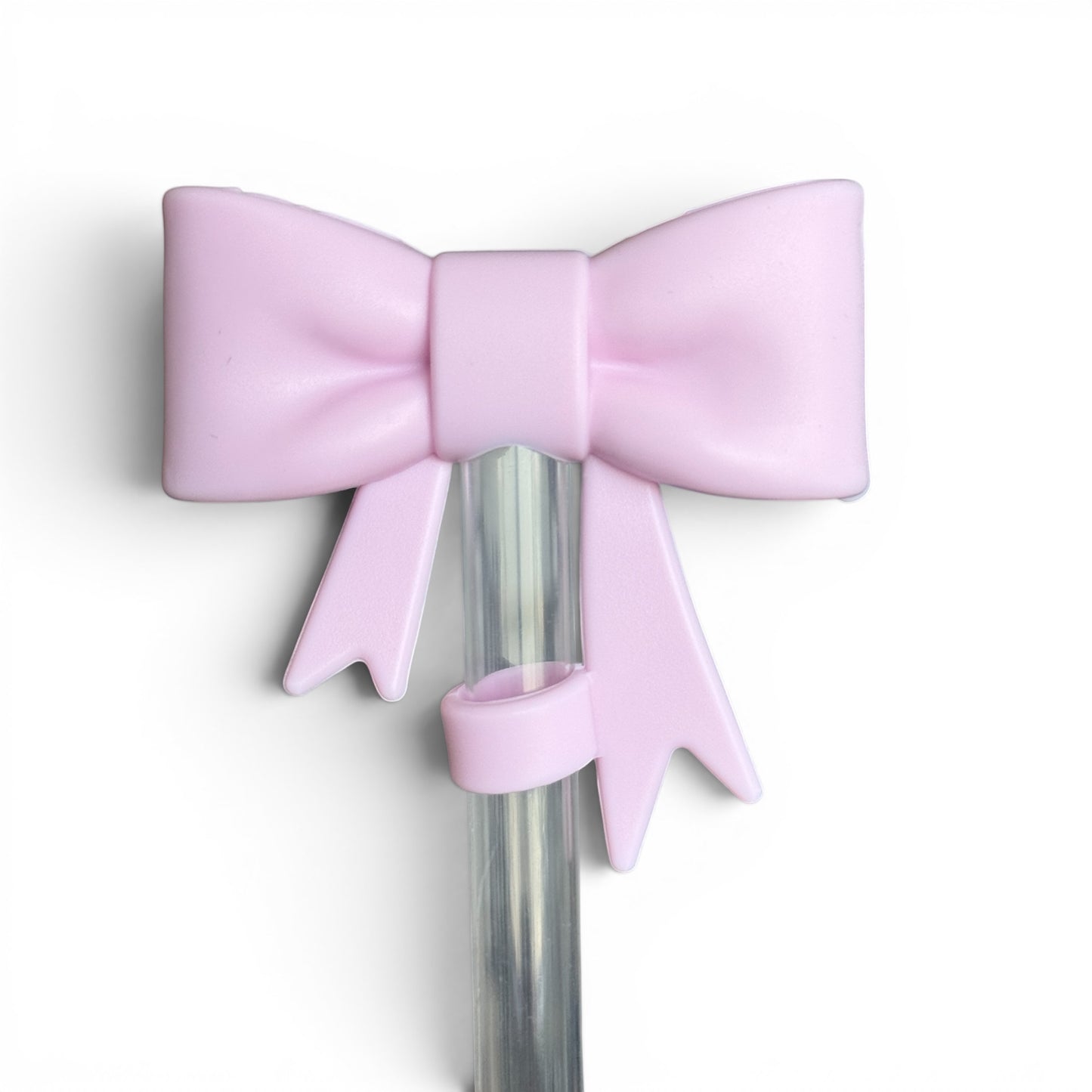 Next Nirvana matte pink silicone 3D bow straw topper for tumblers, featuring a cute bow design on a clear straw.