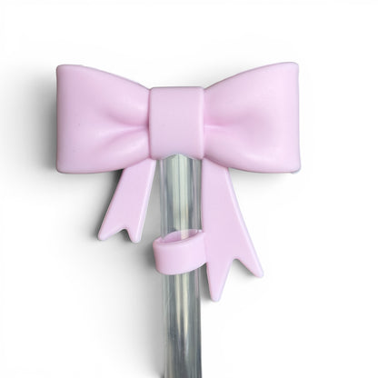 Next Nirvana matte pink silicone 3D bow straw topper for tumblers, featuring a cute bow design on a clear straw.