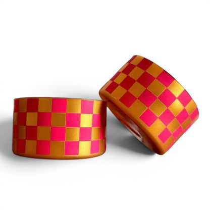 Next Nirvana pink and gold checkered silicone tumbler boot for protective non-slip base on Stanley and other cups