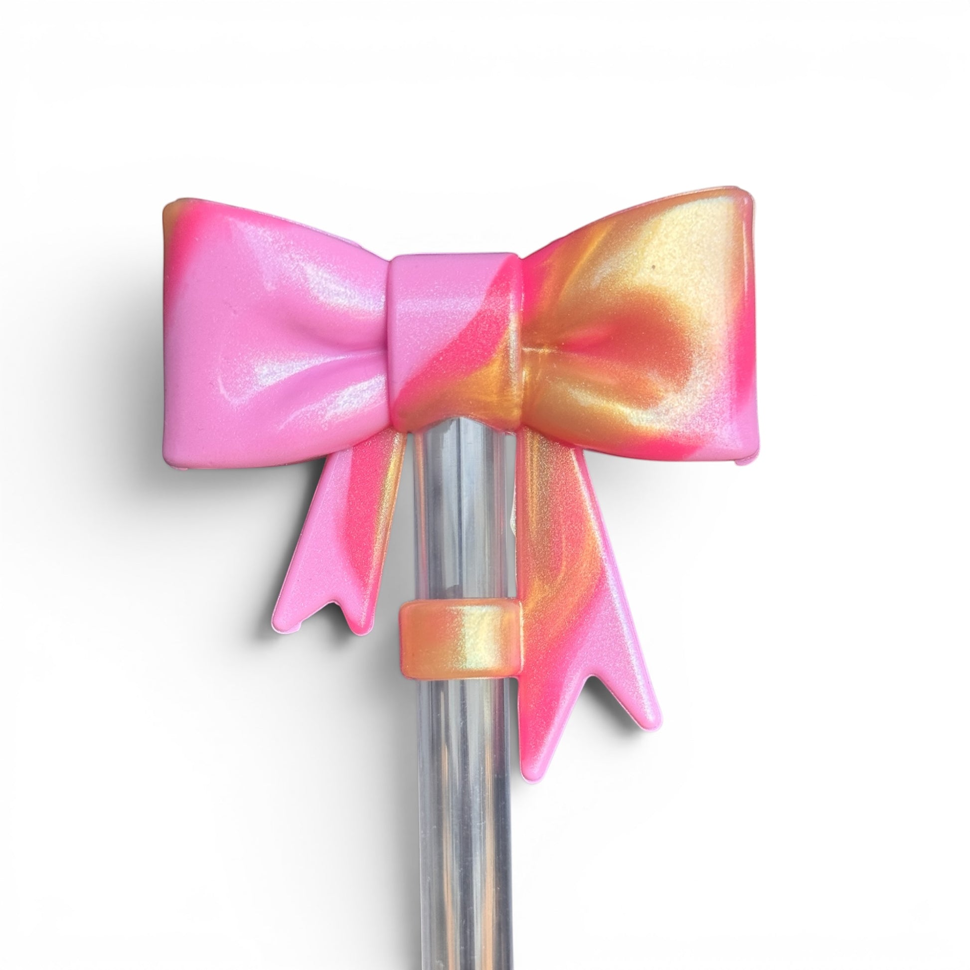 Next Nirvana pink and gold shimmer 3D silicone bow straw topper for tumblers, featuring a marbled pearlescent finish.