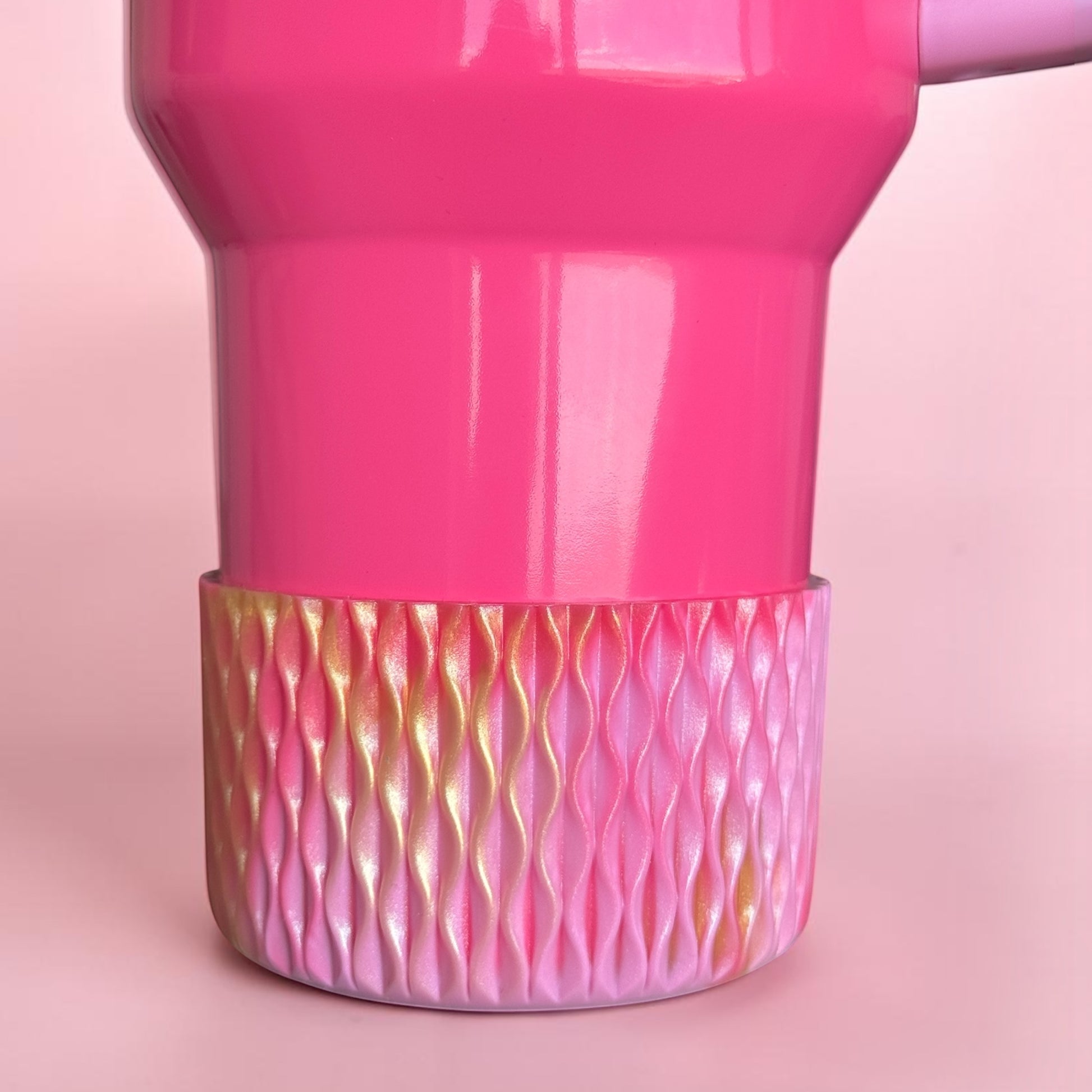 Next Nirvana pink and gold shimmer silicone tumbler boot with 3D wave texture on a matching pink tumbler base.