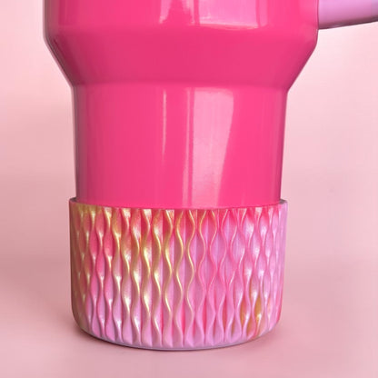 Next Nirvana pink and gold shimmer silicone tumbler boot with 3D wave texture on a matching pink tumbler base.