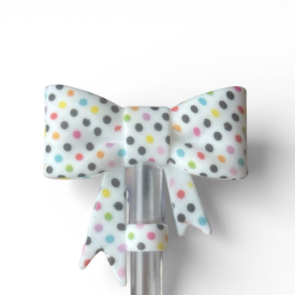 Next Nirvana silicone straw topper featuring a 3D bow design with colorful polka dots for 10mm reusable straws