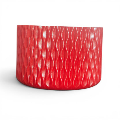 Next Nirvana red silicone tumbler boot with a textured wave pattern for protective non-slip grip on water bottles.