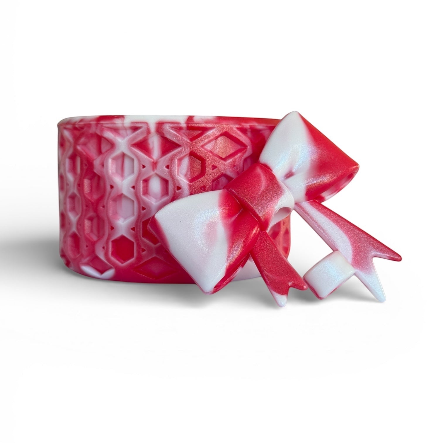 Next Nirvana red and white shimmer waffle-textured silicone tumbler boot with a matching 3D bow straw topper.