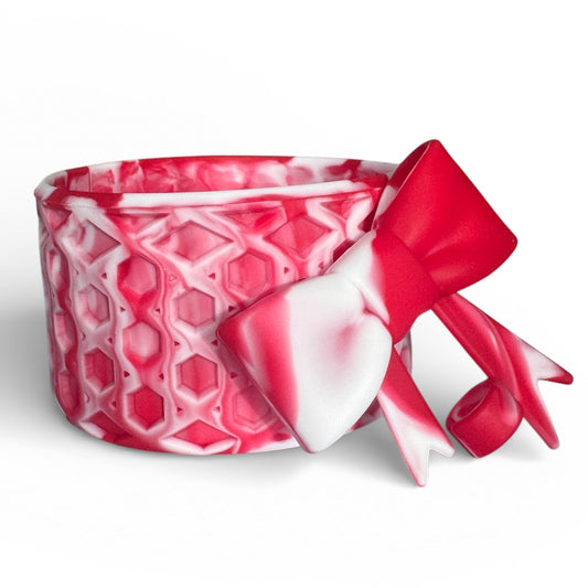 Next Nirvana red and white marble silicone tumbler boot with a matching 3D waffle-textured bow straw topper.