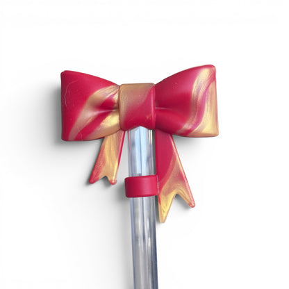Next Nirvana Scarlet Afterglow silicone tumbler boot with a red and gold marbled bow design for Stanley cups.