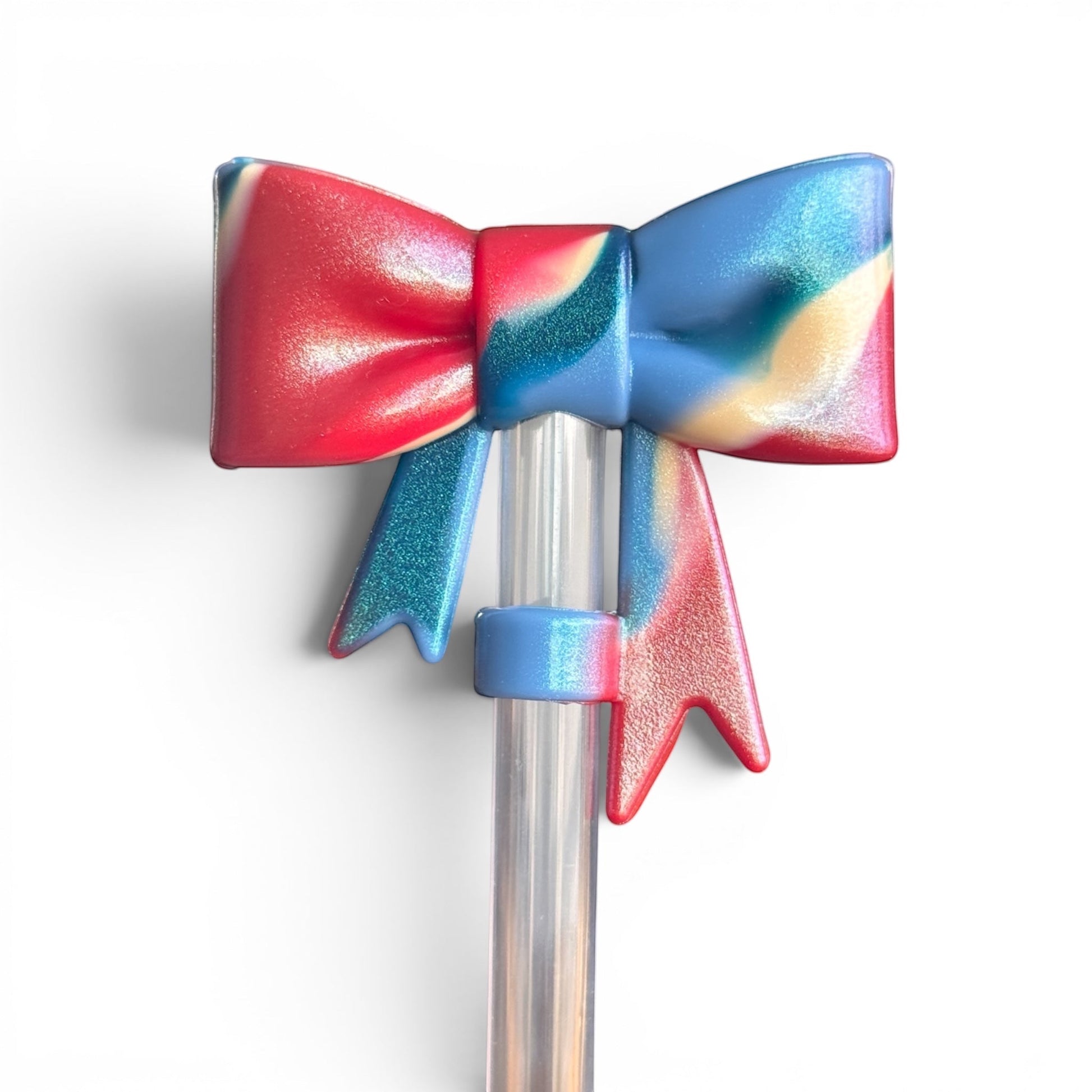 Next Nirvana 3D shimmer bow straw topper in red, blue, and cream swirl silicone for tumblers