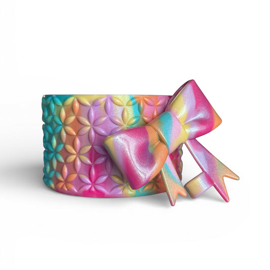 Next Nirvana Summer Splash Shimmer silicone tumbler boot and 3D bow straw topper with a colorful floral pattern.