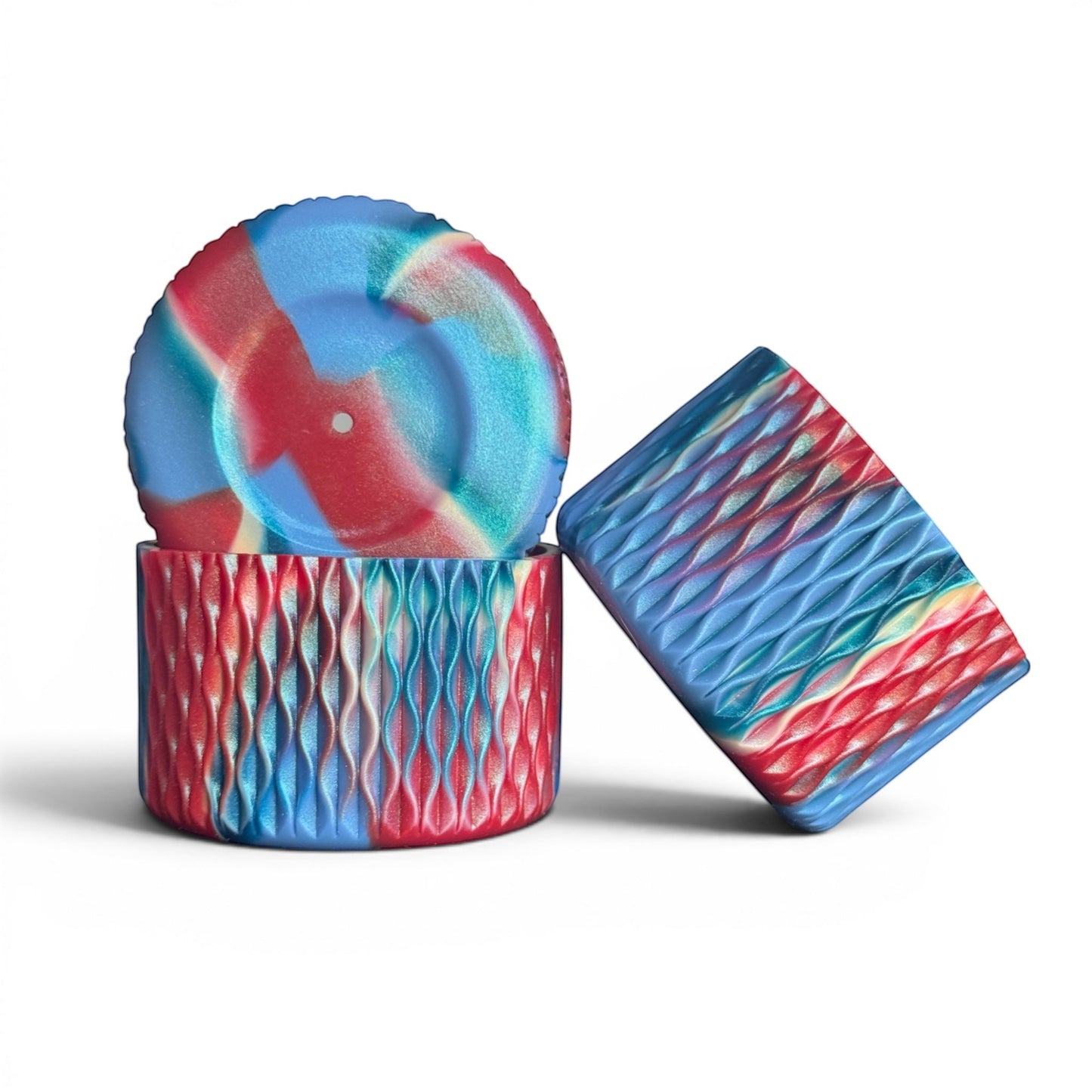 Next Nirvana silicone tumbler boot and 3D bow topper set in a red and blue shimmer wave pattern.