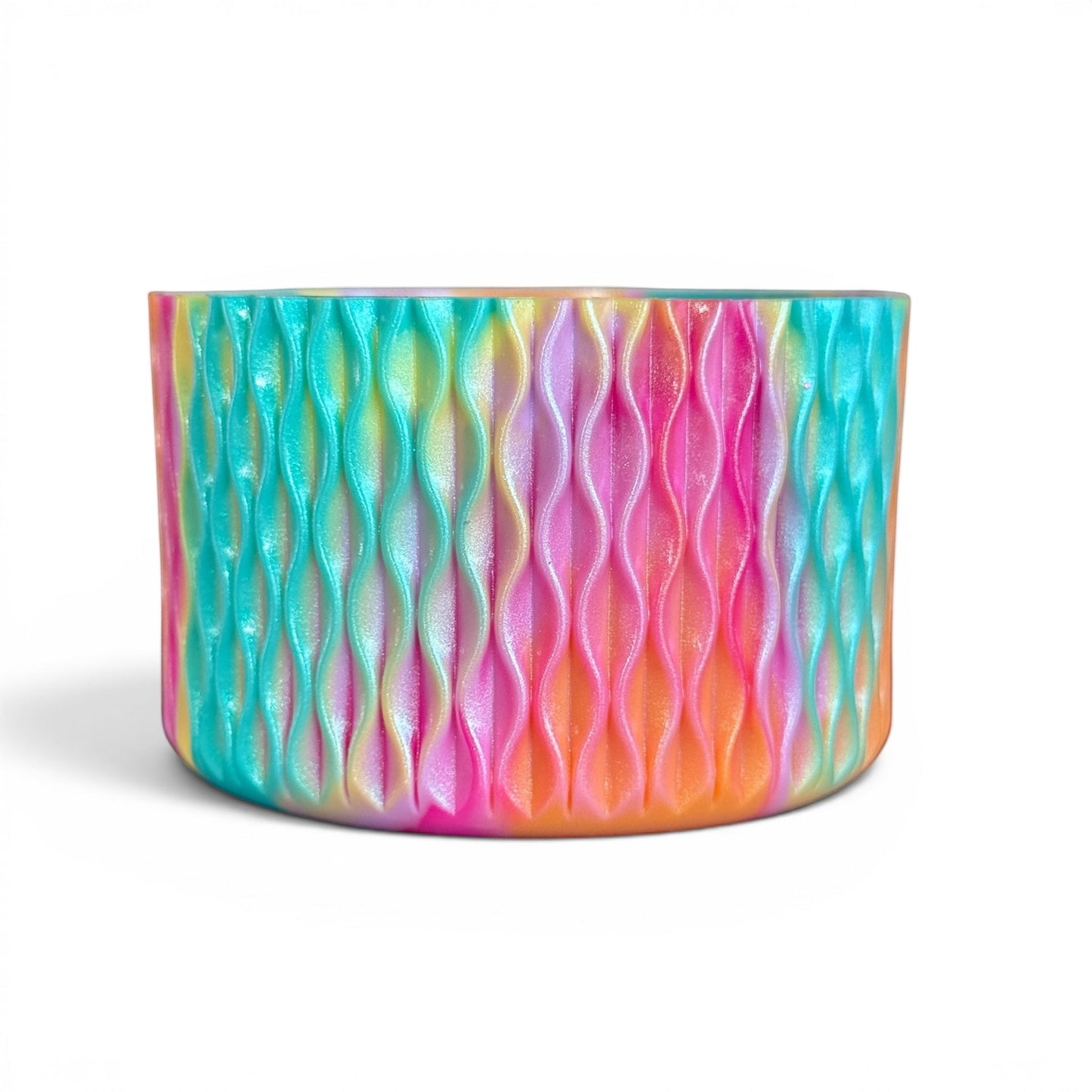 Next Nirvana silicone tumbler boot in a shimmering, multi-colored wave pattern with pink, teal, and orange hues.