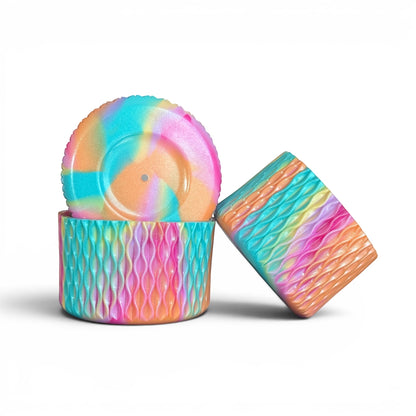 Next Nirvana Summer Splash silicone tumbler boot and 3D bow straw topper set in a shimmering rainbow wave pattern.