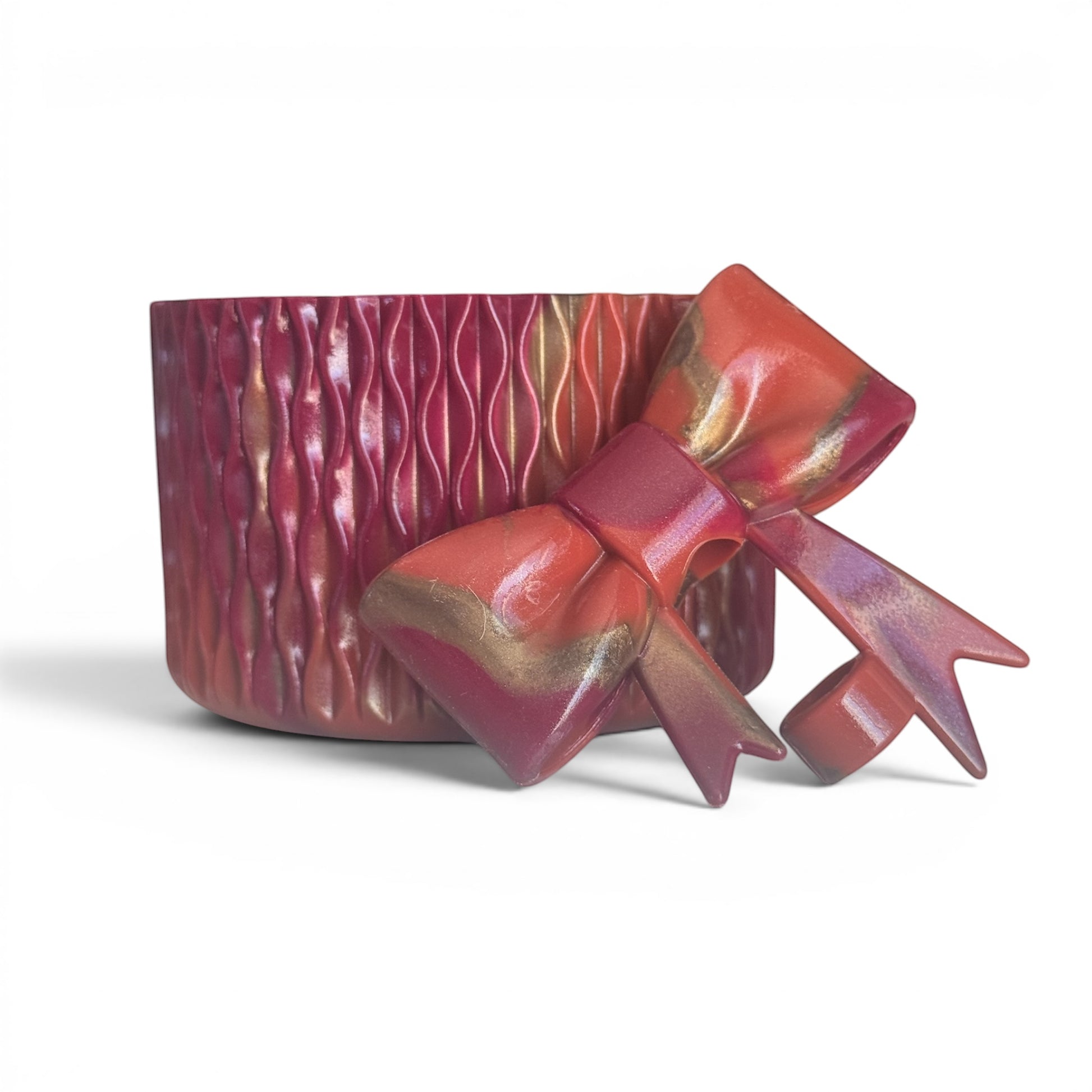 Next Nirvana Country Gold Waves silicone tumbler boot and matching 3D bow straw topper in red and gold swirl pattern.