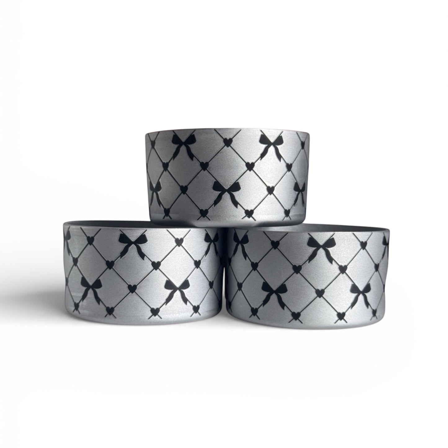 Next Nirvana silver silicone tumbler boot with black criss-cross bow and heart pattern for Stanley and other tumblers.